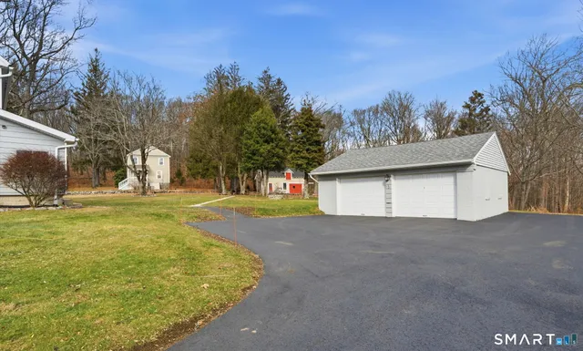 a view of a house with a yard and tree s