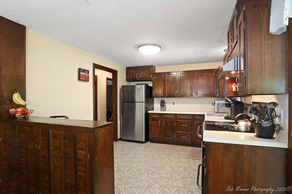 14 Newbury Road Rowley, MA 01969 - Photo 8 of 29 a kitchen with stainless steel appliances a refrigerator sink and cabinets