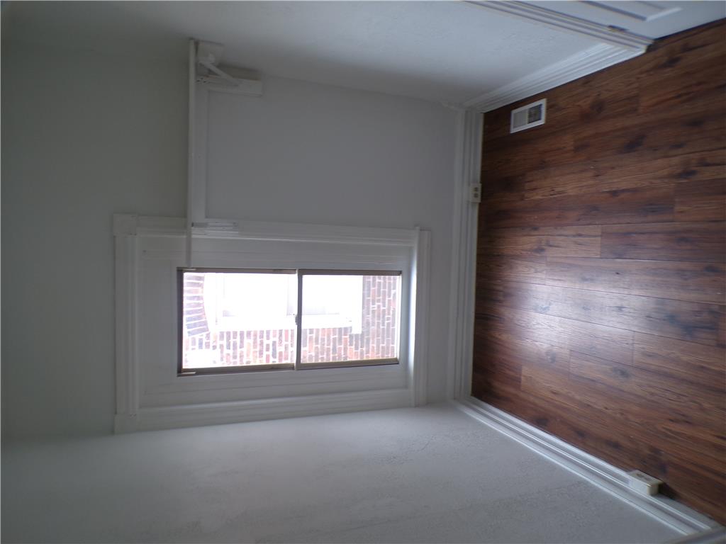 111 Ridge Avenue Allentown, PA 18102 - Photo 9 of 15 An inviting room features both plush carpeting and rich wood-style flooring, ready for comfortable living.