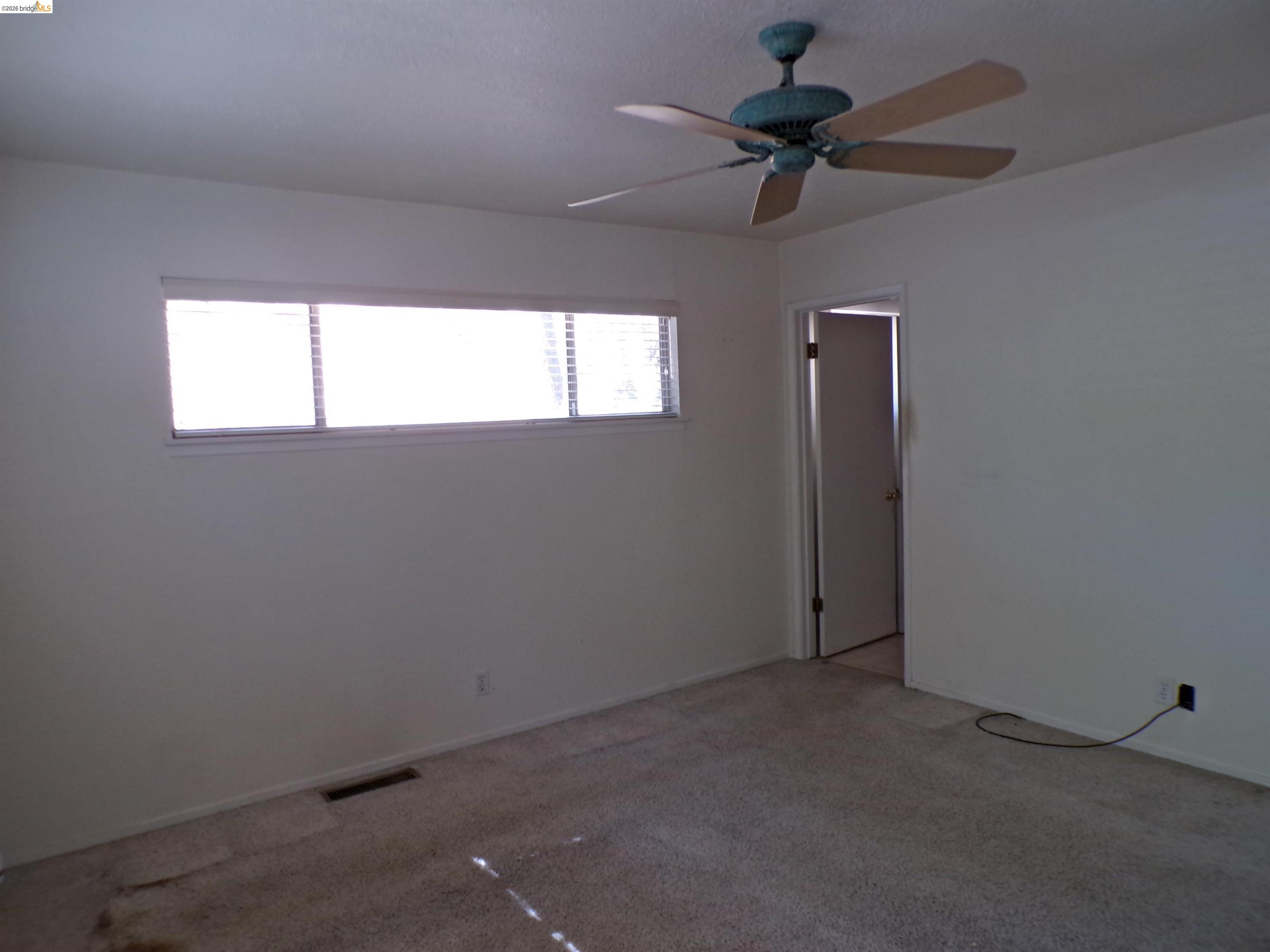 20663 Haiapo Road Mi Wuk Village, CA 95346 - Photo 12 of 24 a view of an empty room and a ceiling fan and window