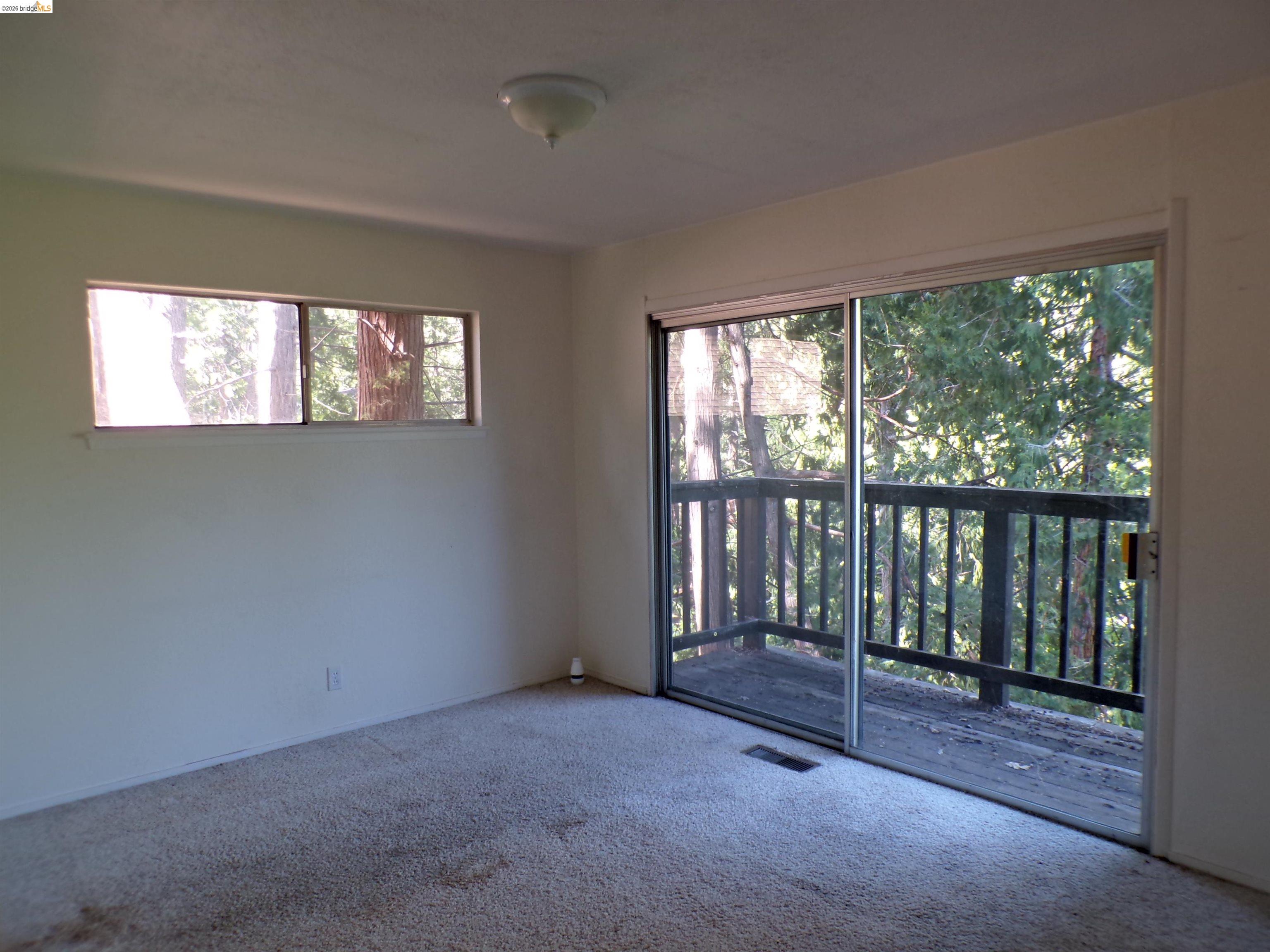20663 Haiapo Road Mi Wuk Village, CA 95346 - Photo 15 of 24 a view of an empty room with wooden floor and a window