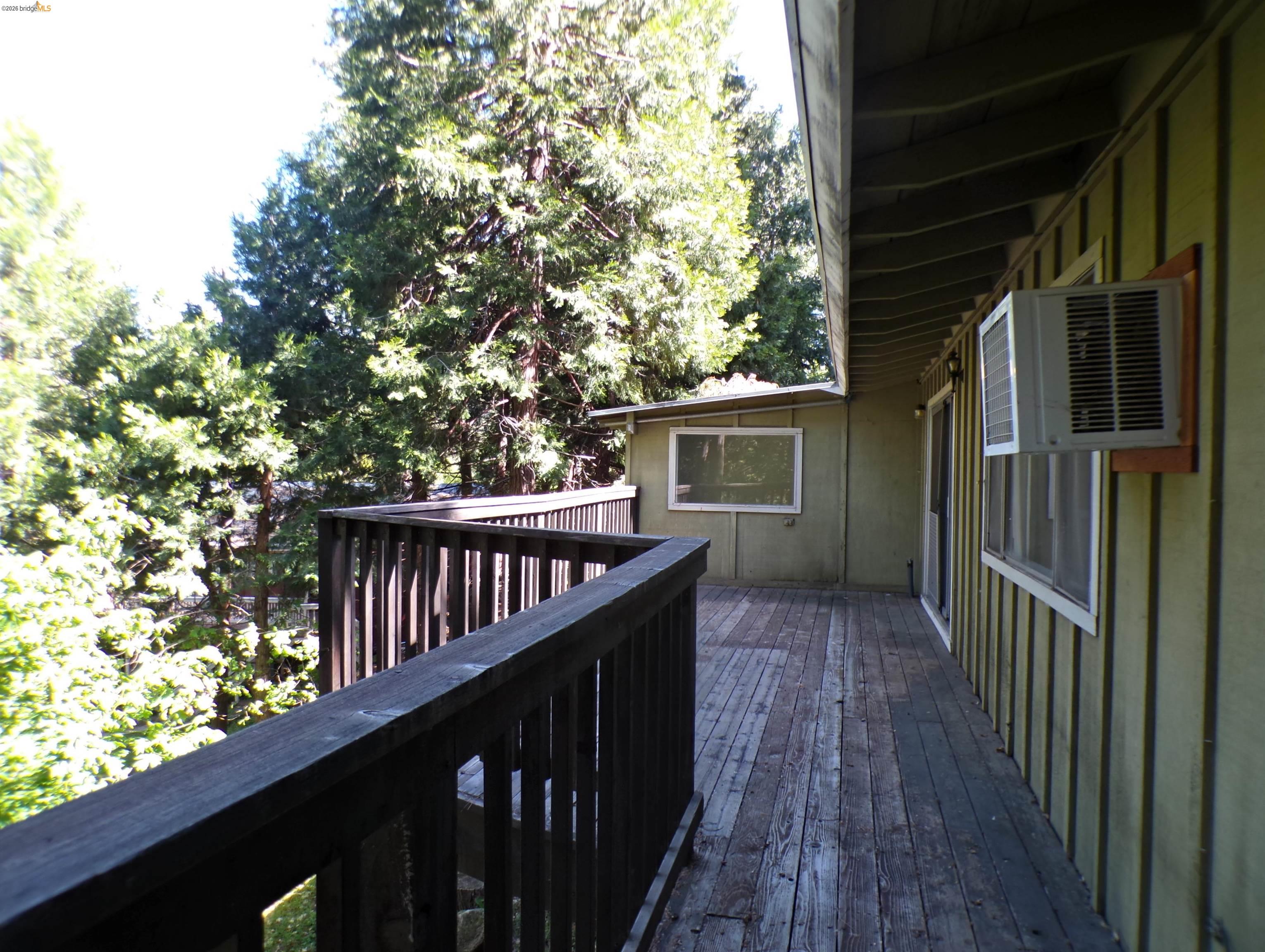 20663 Haiapo Road Mi Wuk Village, CA 95346 - Photo 19 of 24 a view of balcony with wooden floor and fence