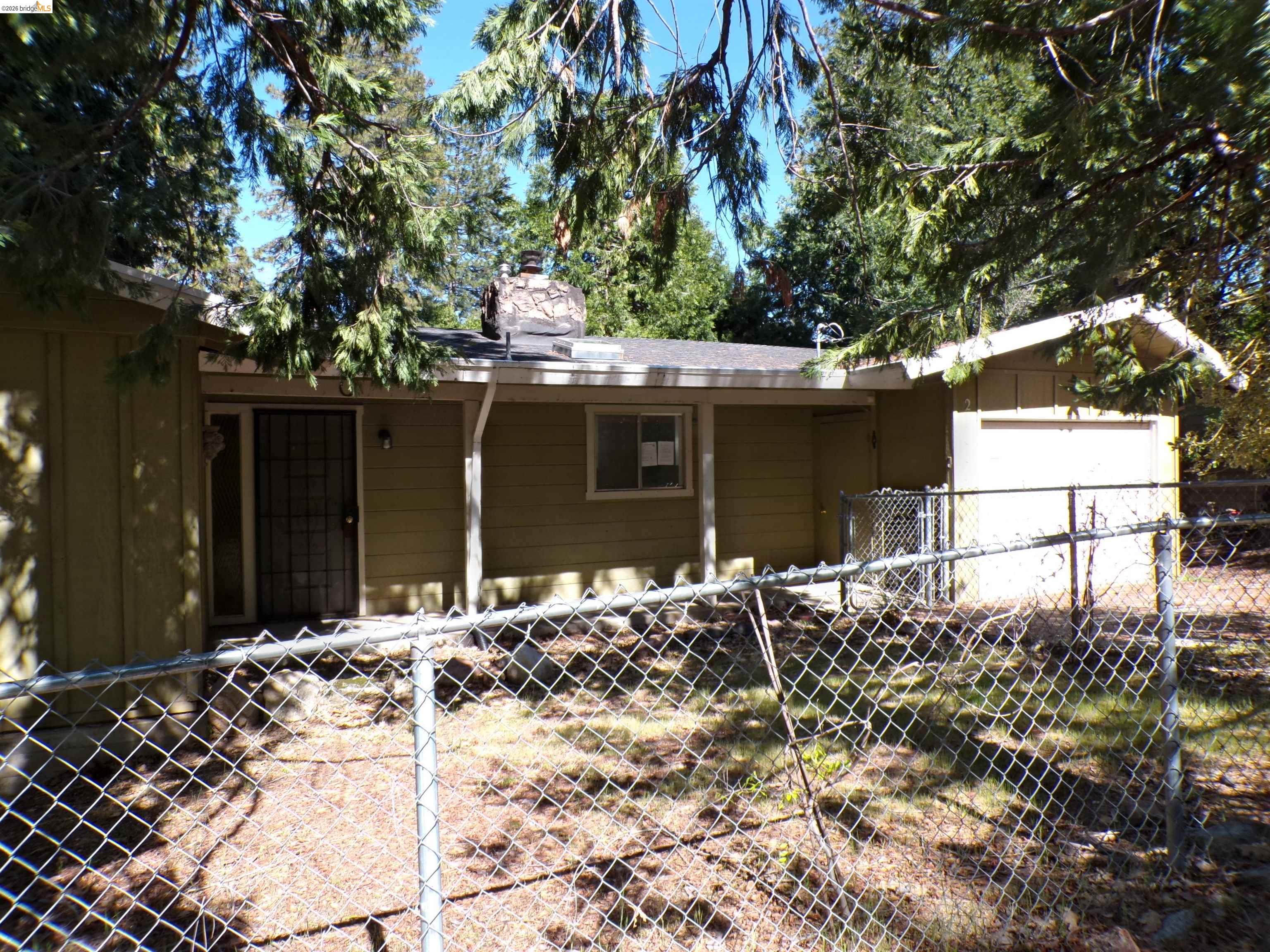 20663 Haiapo Road Mi Wuk Village, CA 95346 - Photo 4 of 24 front view of a house with a large tree