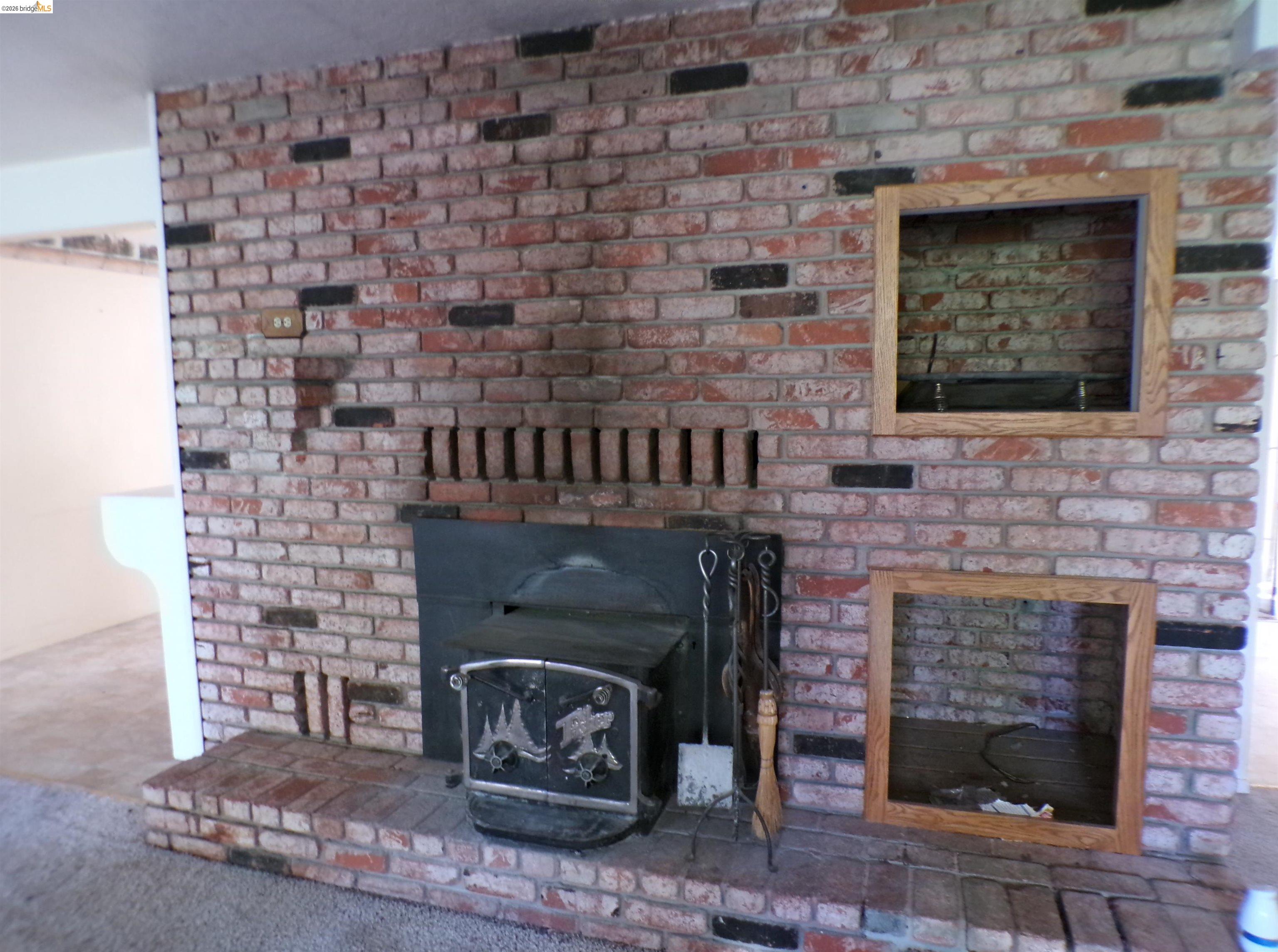 20663 Haiapo Road Mi Wuk Village, CA 95346 - Photo 10 of 24 a stone fireplace with a fireplace