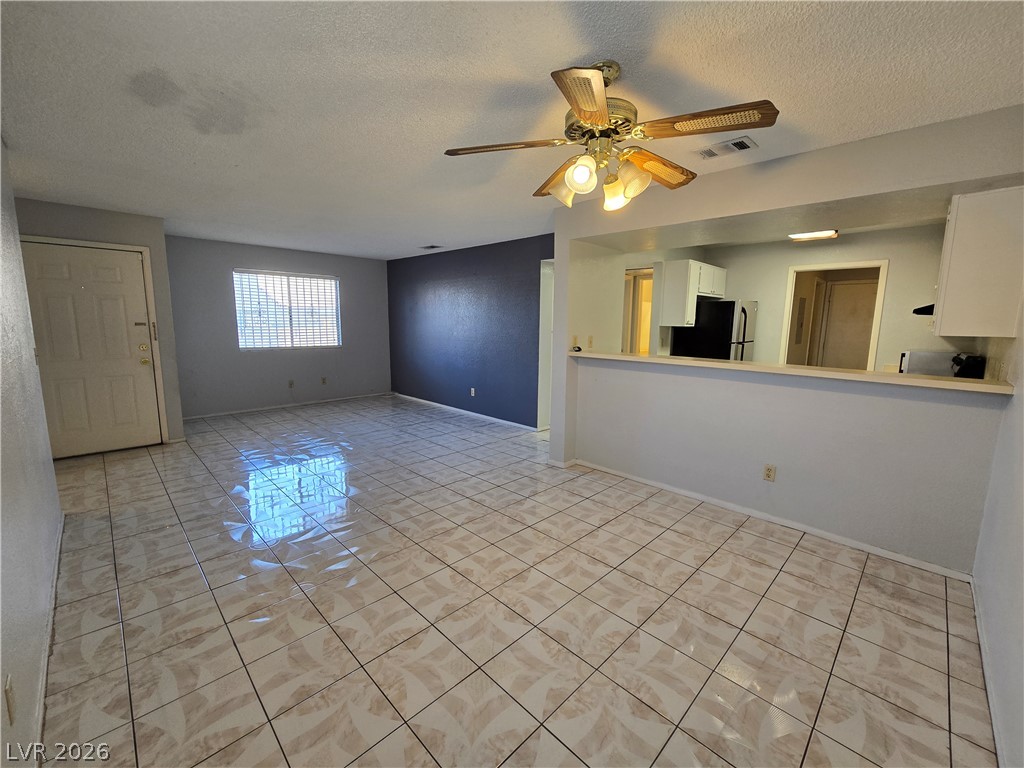 6750 Del Rey Avenue, Unit 133 Las Vegas, NV 89146 - Photo 34 of 34 An open floorplan offers a functional living space with easy access to the adjacent kitchen.