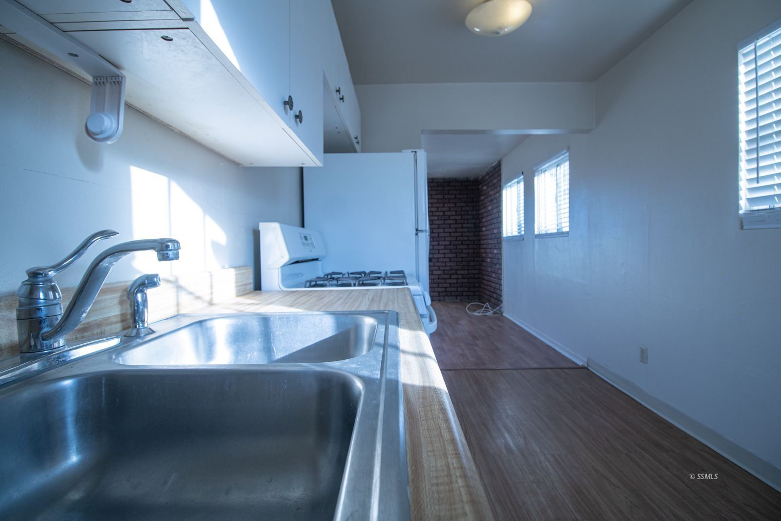 1621 Sims Street Ridgecrest, CA 93555 - Photo 8 of 24 a kitchen with a sink and chandelier