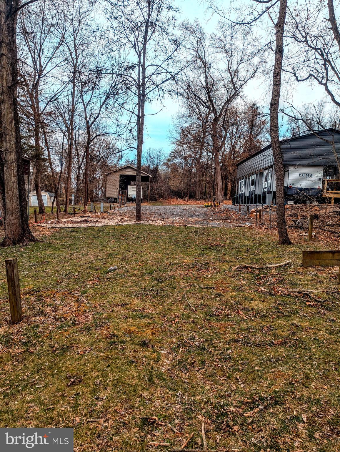 12 Bear Bottom Road Falling Waters, WV 25419 - Photo 1 of 1 a view of a yard with a house in the background