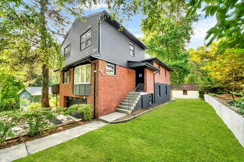 a front view of house with yard and green space
