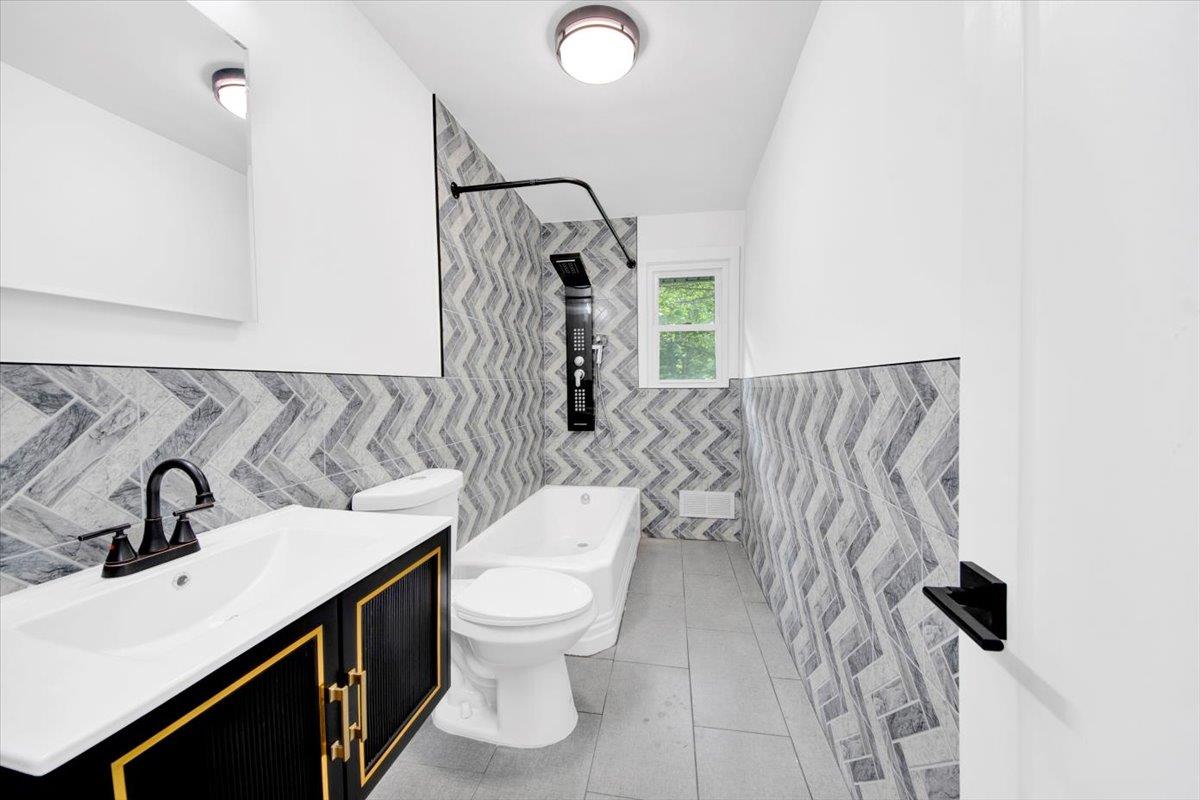 132 Holmes Avenue Hartsdale, NY 10530 - Photo 13 of 34 a bathroom with a toilet sink and mirror