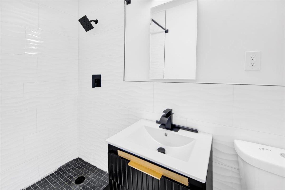 132 Holmes Avenue Hartsdale, NY 10530 - Photo 16 of 34 a bathroom with a sink a toilet and a shower