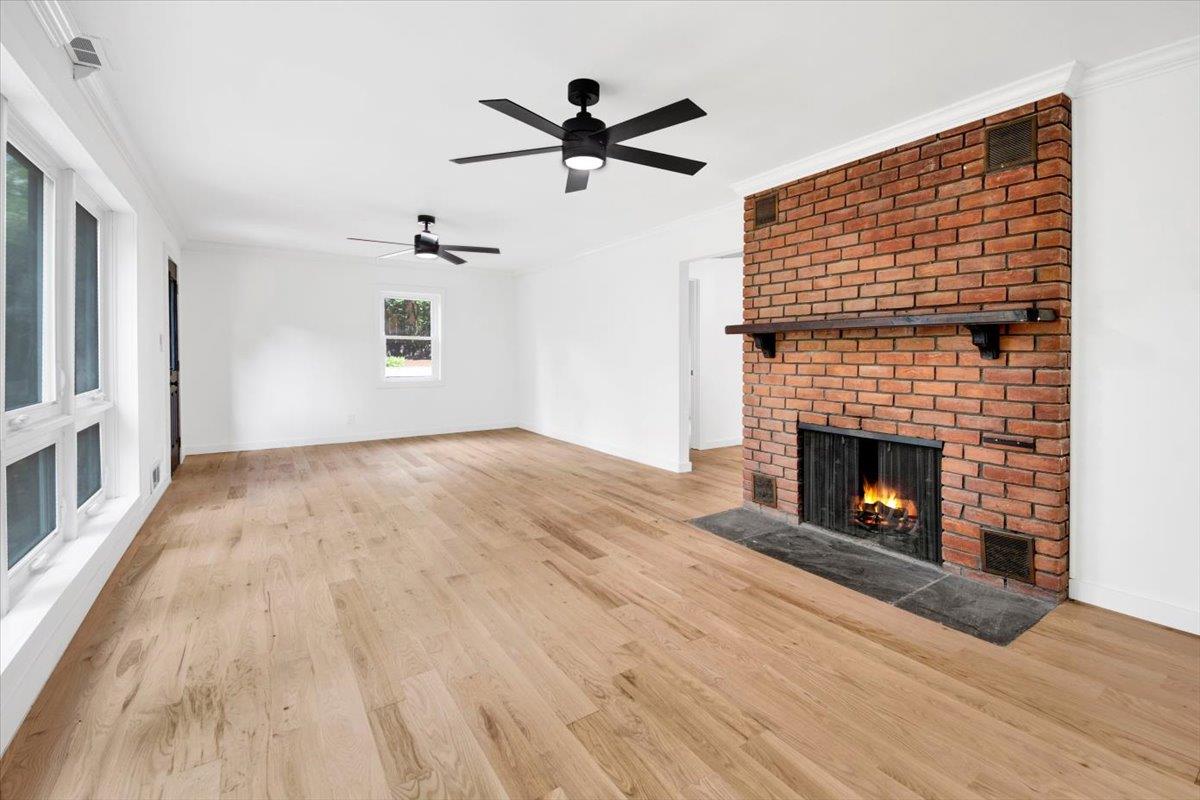 132 Holmes Avenue Hartsdale, NY 10530 - Photo 21 of 34 a view of a livingroom with a fireplace a ceiling fan and wooden floor