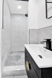 a view of a room with wooden floor and small window