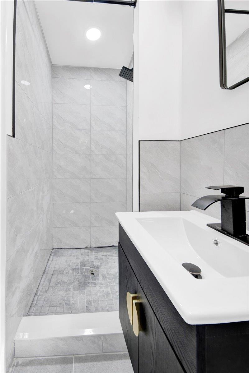 132 Holmes Avenue Hartsdale, NY 10530 - Photo 23 of 34 a bathroom with a sink and a mirror