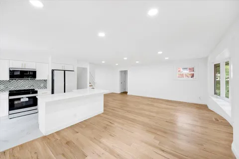 a view of a kitchen with microwave and cabinets