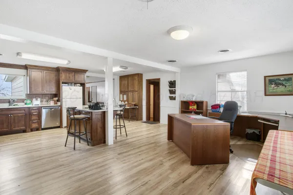a view of workspace with wooden floor windows