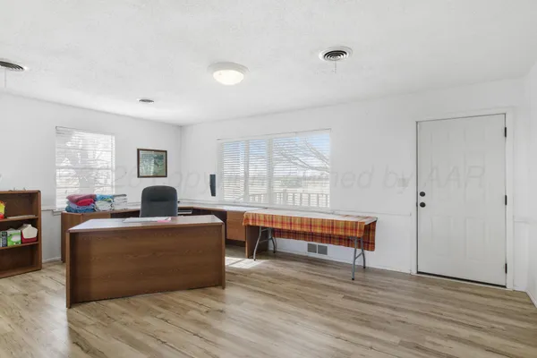 a kitchen with stainless steel appliances granite countertop a stove top oven a sink and dishwasher a refrigerator with wooden cabinets