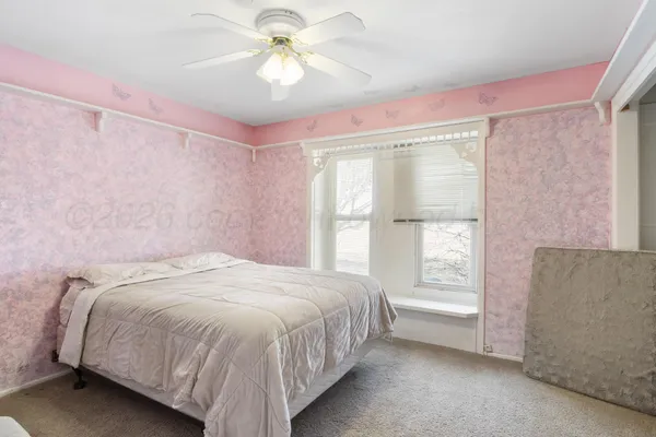 a bathroom with a toilet sink a mirror and vanity