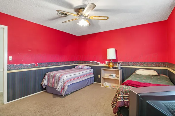 a view of empty room with fireplace and fan