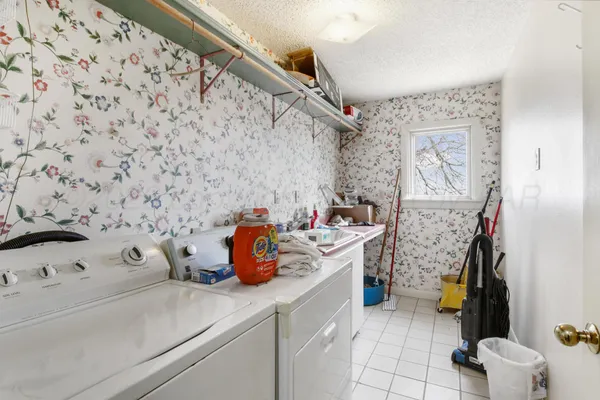 a front view of house with yard and trees