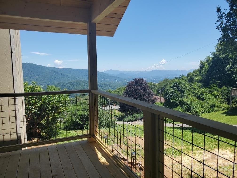200 Atari Road, Unit 8 Waynesville, NC 28786 - Photo 5 of 23 a view of balcony with floor to ceiling windows with wooden floor