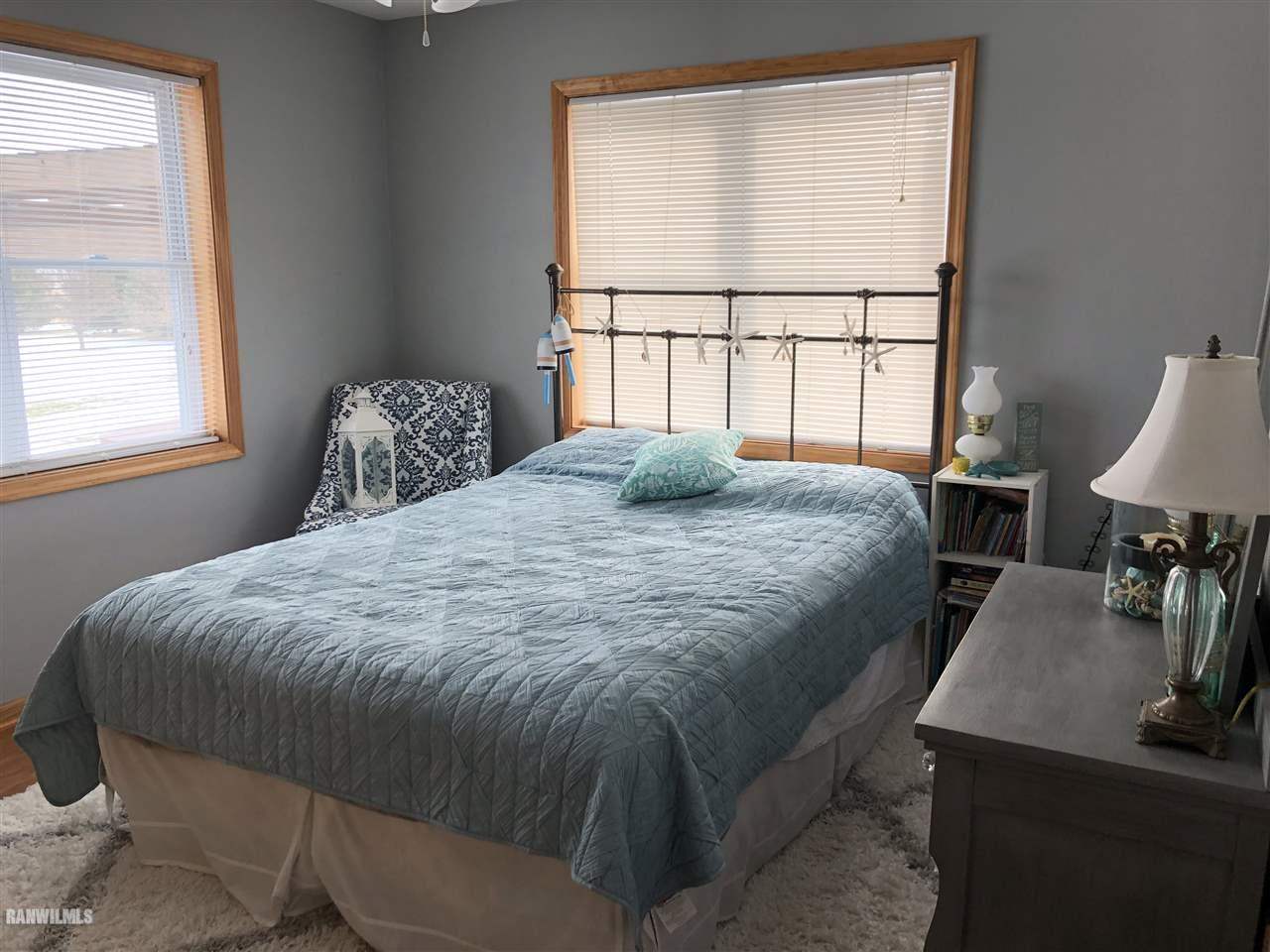 7695 East Winneshiek Road Ridott, IL 61067 - Photo 11 of 15 a bedroom with a bed and window