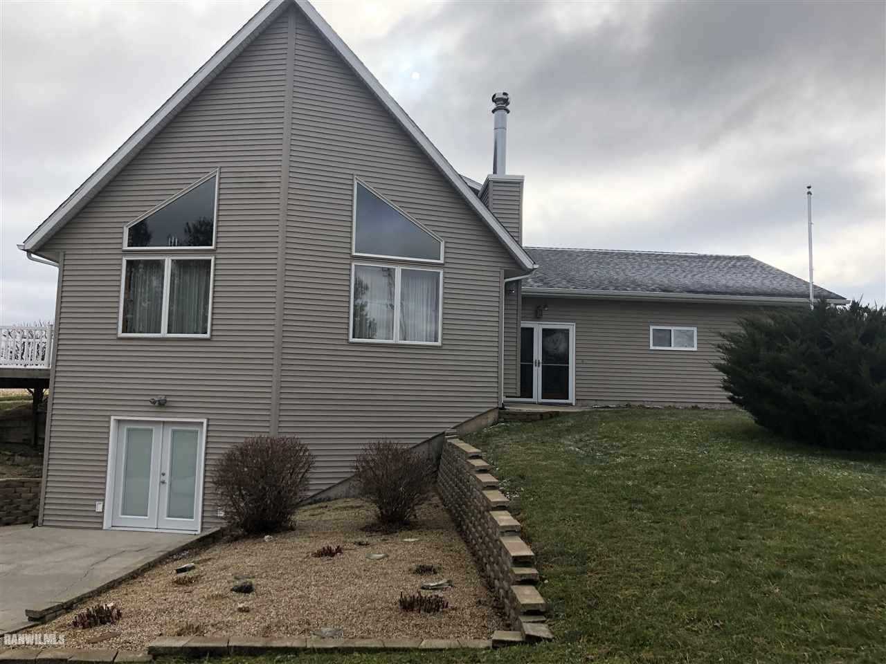 7695 East Winneshiek Road Ridott, IL 61067 - Photo 14 of 15 a front view of a house with garden