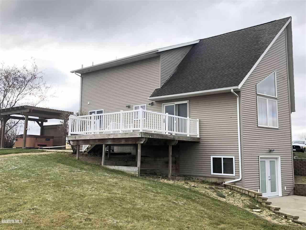 7695 East Winneshiek Road Ridott, IL 61067 - Photo 15 of 15 a view of a house with a wooden deck and a yard