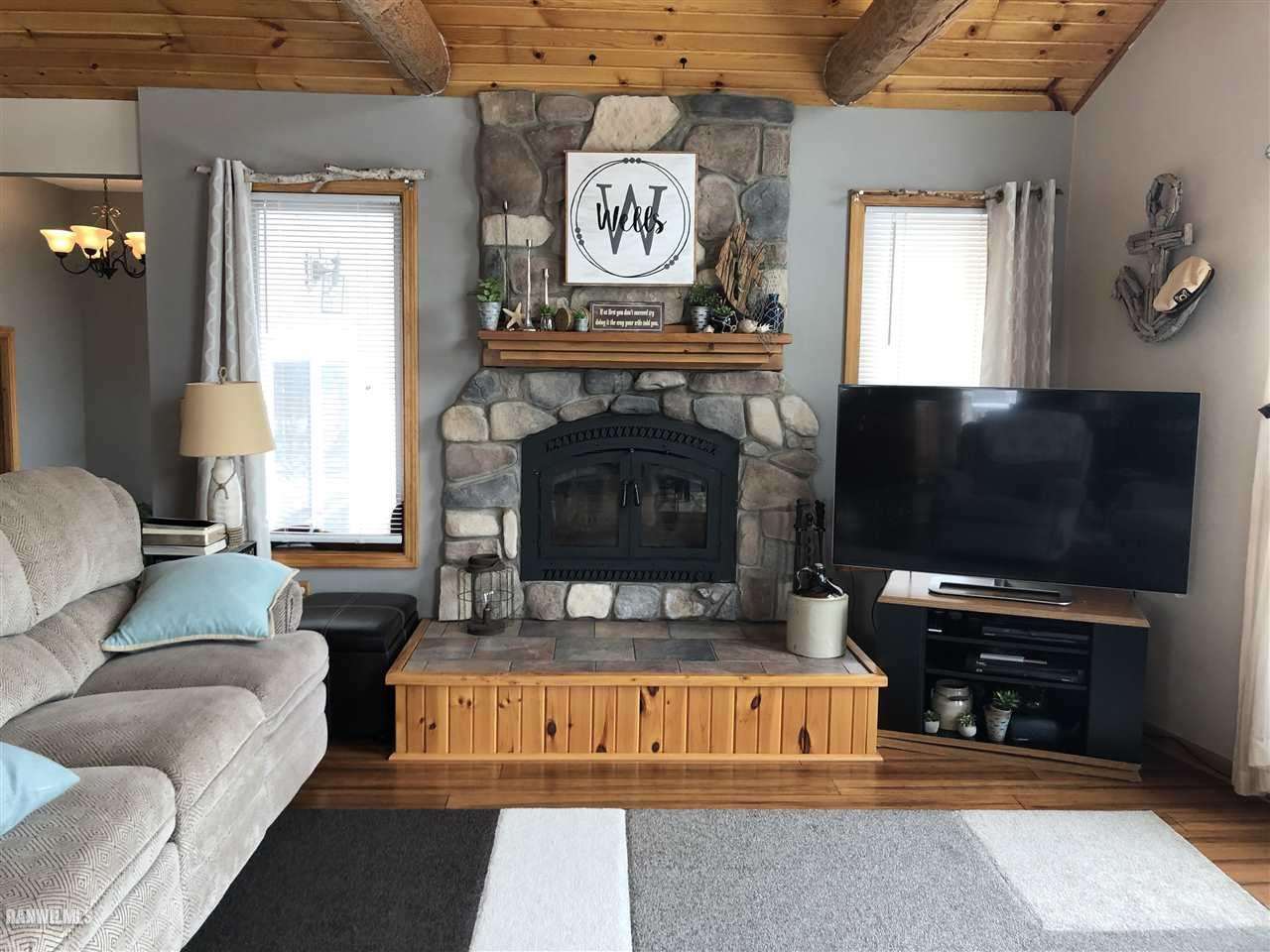 7695 East Winneshiek Road Ridott, IL 61067 - Photo 3 of 15 a living room with furniture and a fireplace