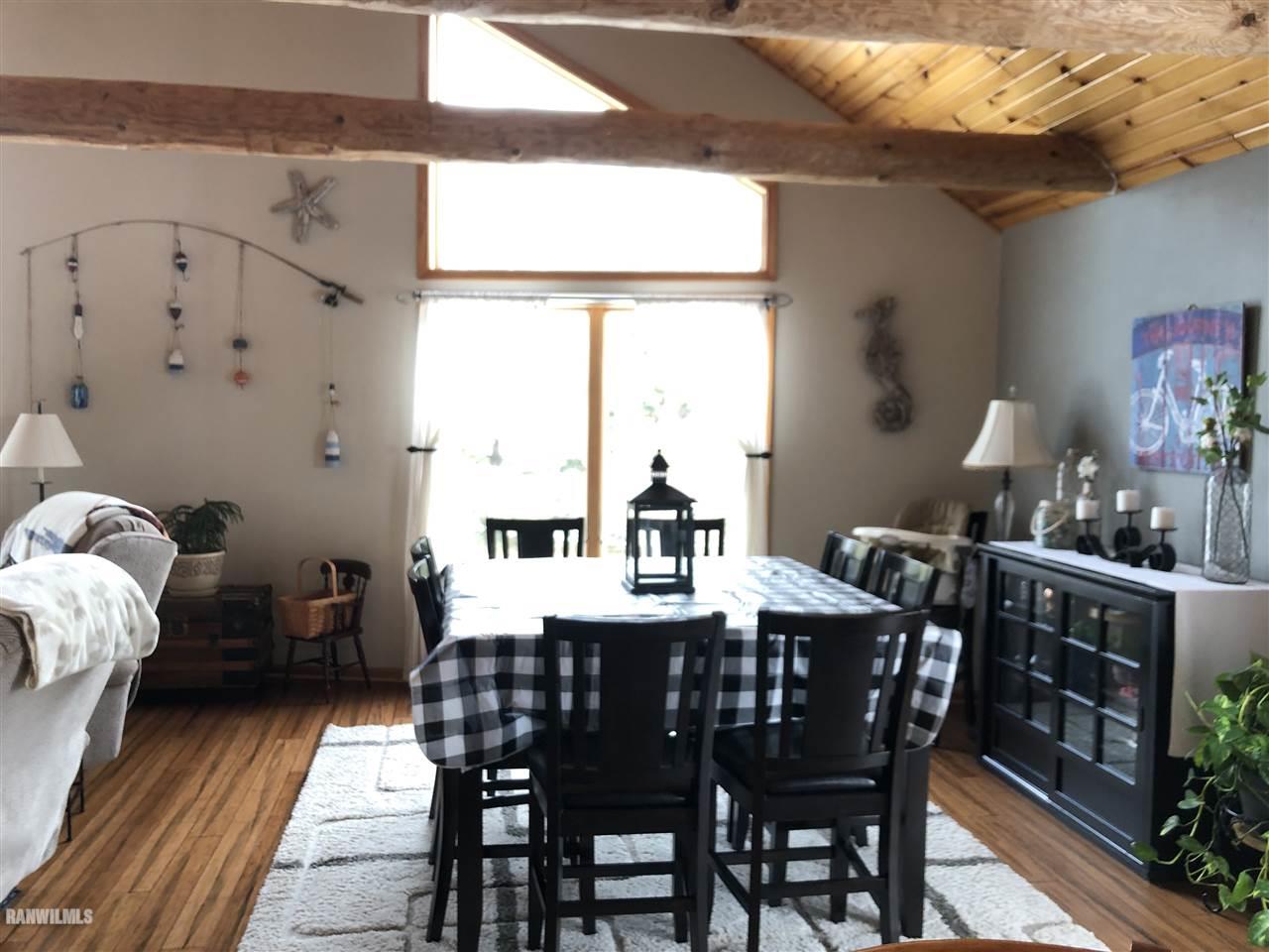 7695 East Winneshiek Road Ridott, IL 61067 - Photo 4 of 15 a view of a dining room with furniture window and wooden floor