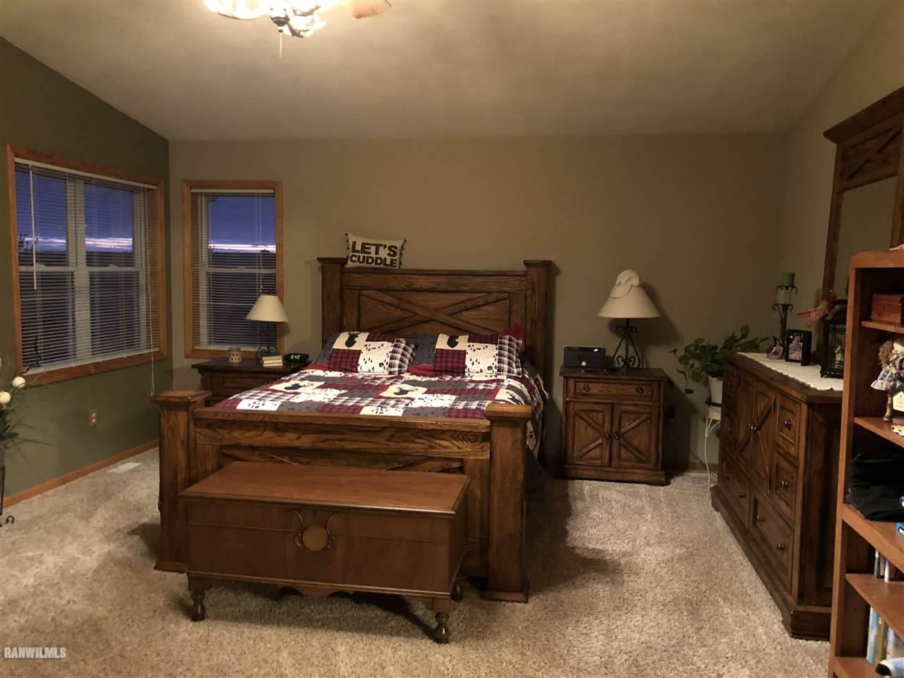 7695 East Winneshiek Road Ridott, IL 61067 - Photo 9 of 15 a room with fireplace furniture and a flat screen tv