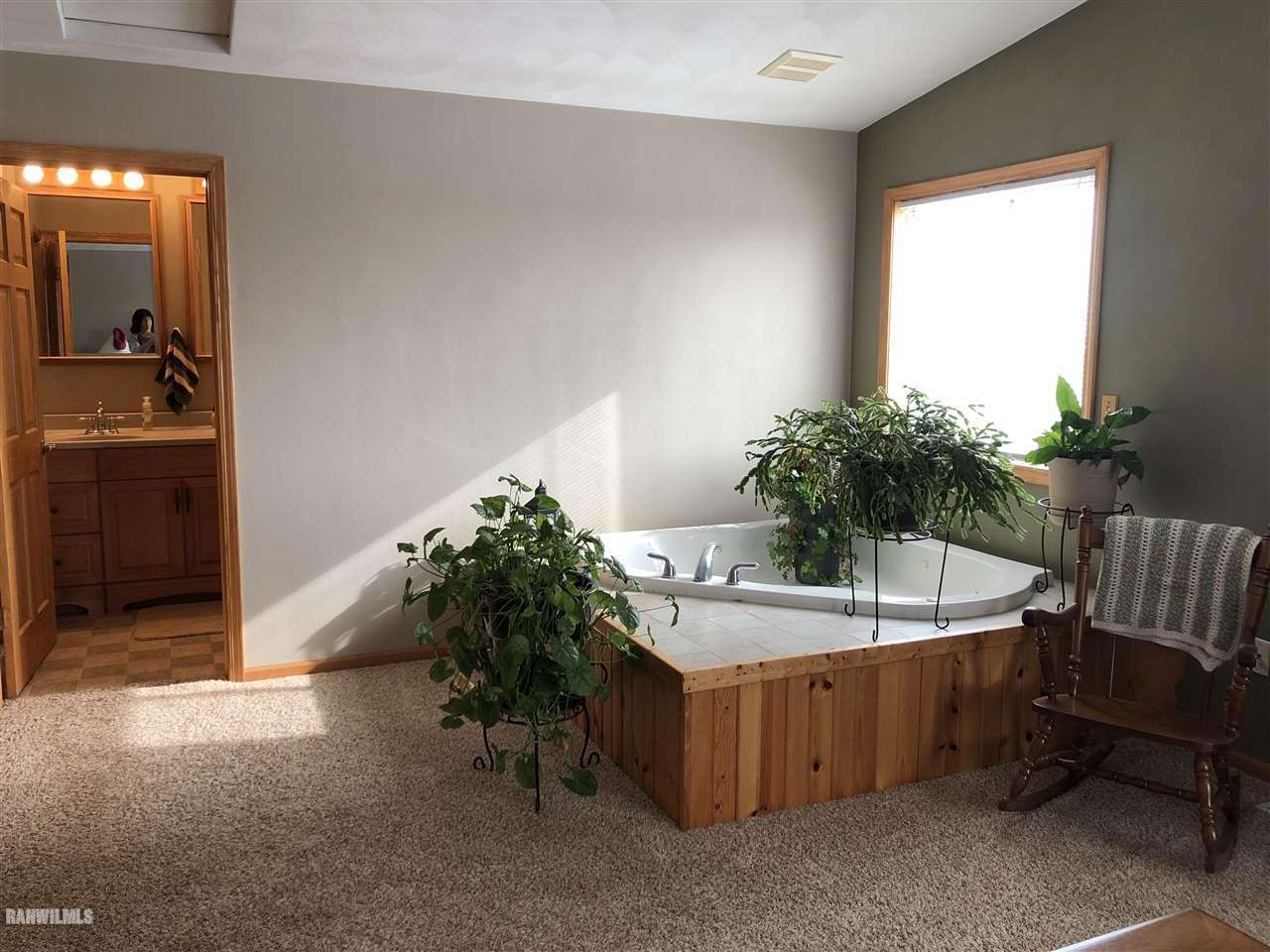 7695 East Winneshiek Road Ridott, IL 61067 - Photo 10 of 15 a spacious bathroom with a sink and a bathtub