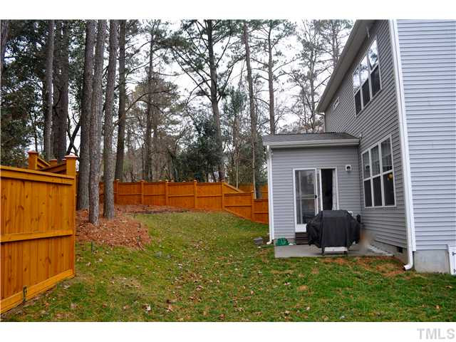 808 Pirouette Court Raleigh, NC 27606 - Photo 22 of 25 Fully fenced yard with hardwood trees, flower/garden beds and sprinklers.