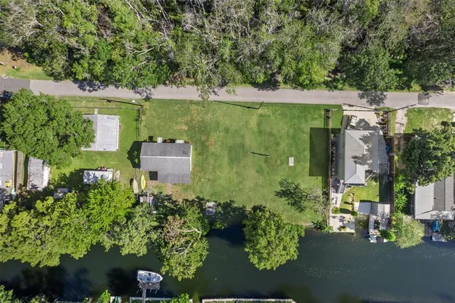 an aerial view of a house with a yard basket ball court and outdoor seating