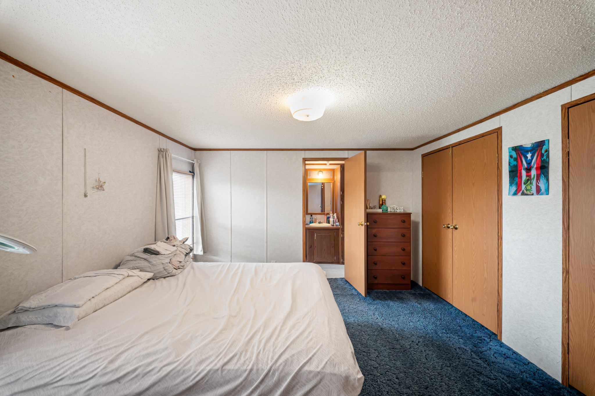 1777 Pond River Road Elkton, KY 42220 - Photo 16 of 21 a bedroom with a large bed and a chandelier