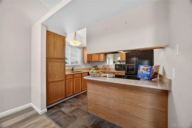 a kitchen with stainless steel appliances a refrigerator and a stove