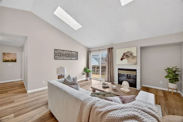 a living room with furniture flat screen tv and a fireplace