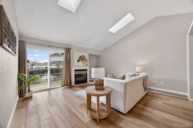 a living room with furniture a fireplace and a table