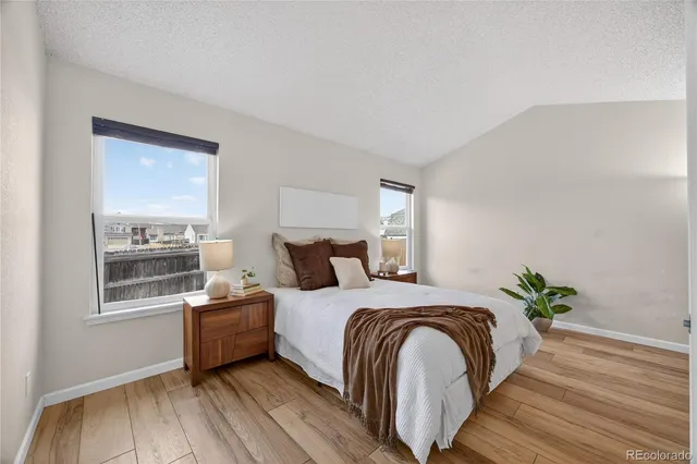 a bedroom with double bed and a potted plant