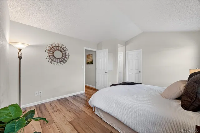 a bedroom with a bed and a potted plant