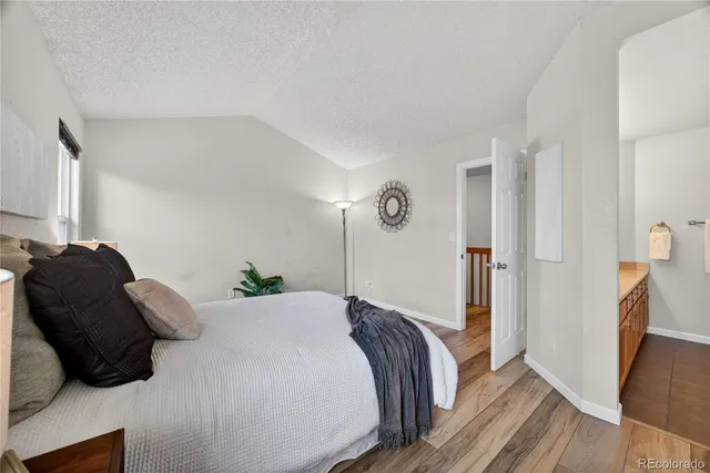 a bedroom with a bed and a refrigerator