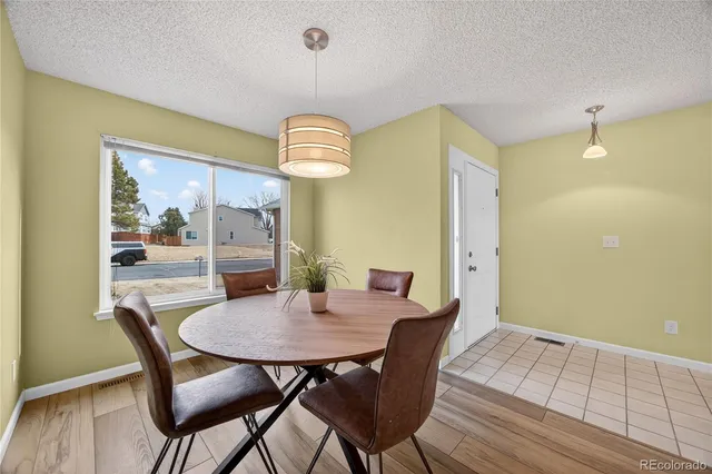 a view of a dining room with furniture wooden floor and chandelier