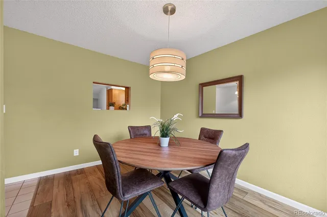 a view of a dining room with a table and chairs