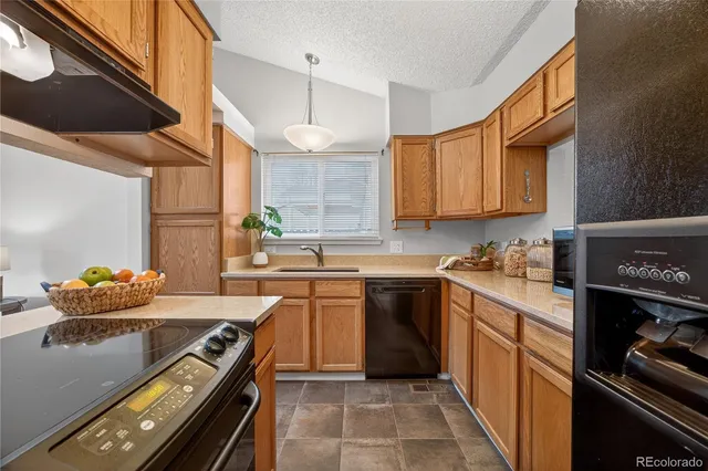 a kitchen with stainless steel appliances granite countertop a stove and a sink