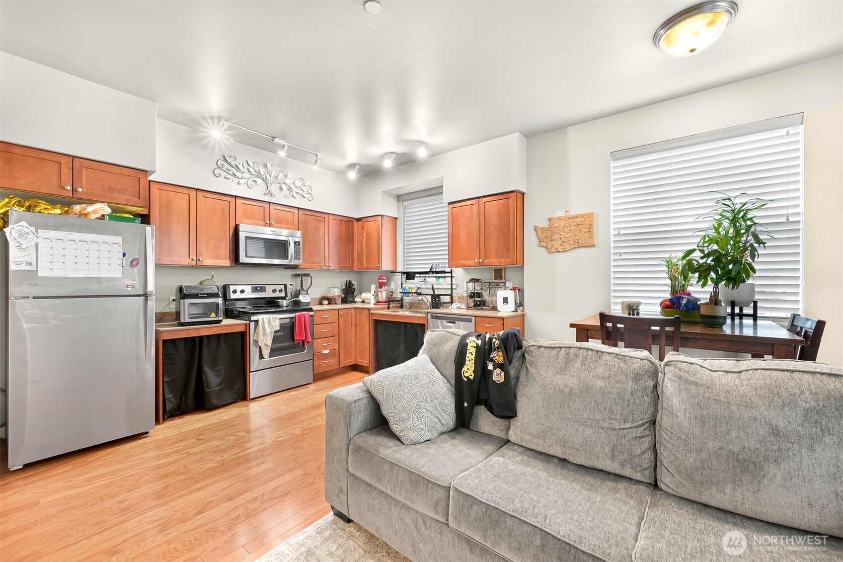 8844 Depot Road, Unit B112 Lynden, WA 98264 - Photo 5 of 27 a kitchen with stainless steel appliances granite countertop a refrigerator a sink dishwasher a oven with a dining table and chairs