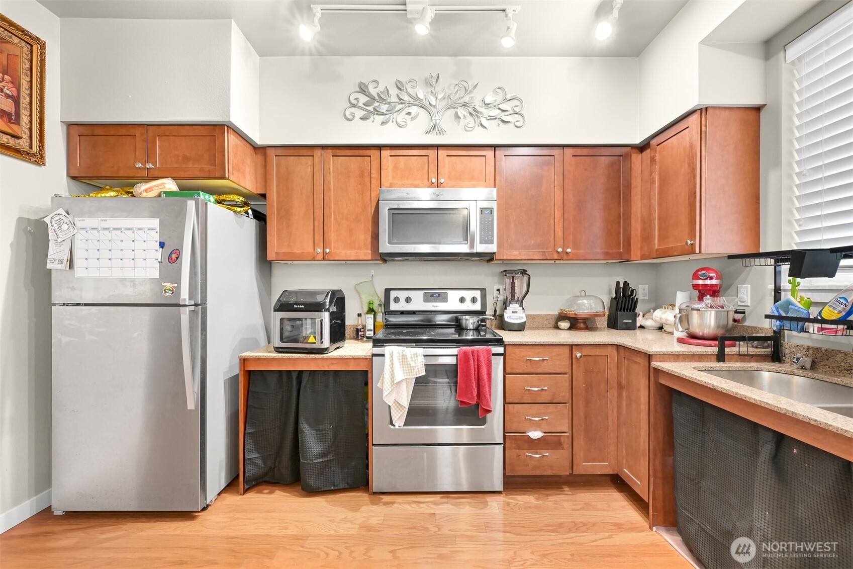 8844 Depot Road, Unit B112 Lynden, WA 98264 - Photo 9 of 27 a kitchen with stainless steel appliances granite countertop a refrigerator stove and sink