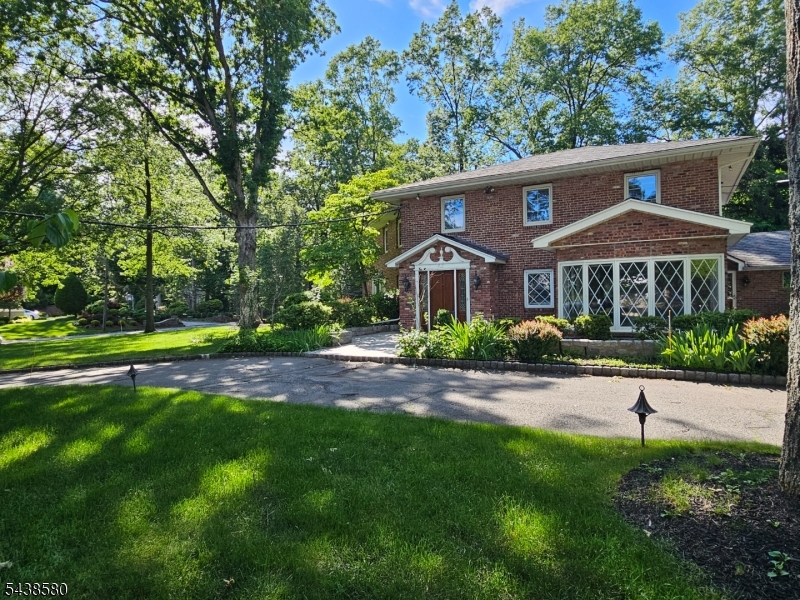 218 Devon Road Essex Fells, NJ 07021 - Photo 4 of 24 a front view of a house with a yard