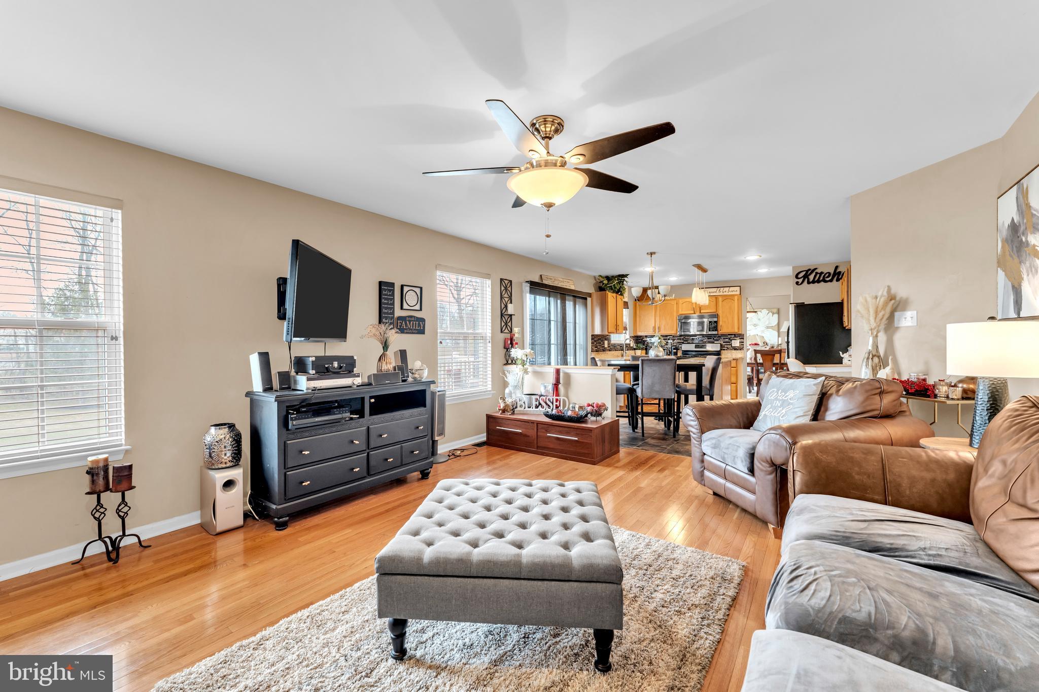 5660 Compton Lane Eldersburg, MD 21784 - Photo 12 of 44 a living room with furniture a flat screen tv and kitchen view