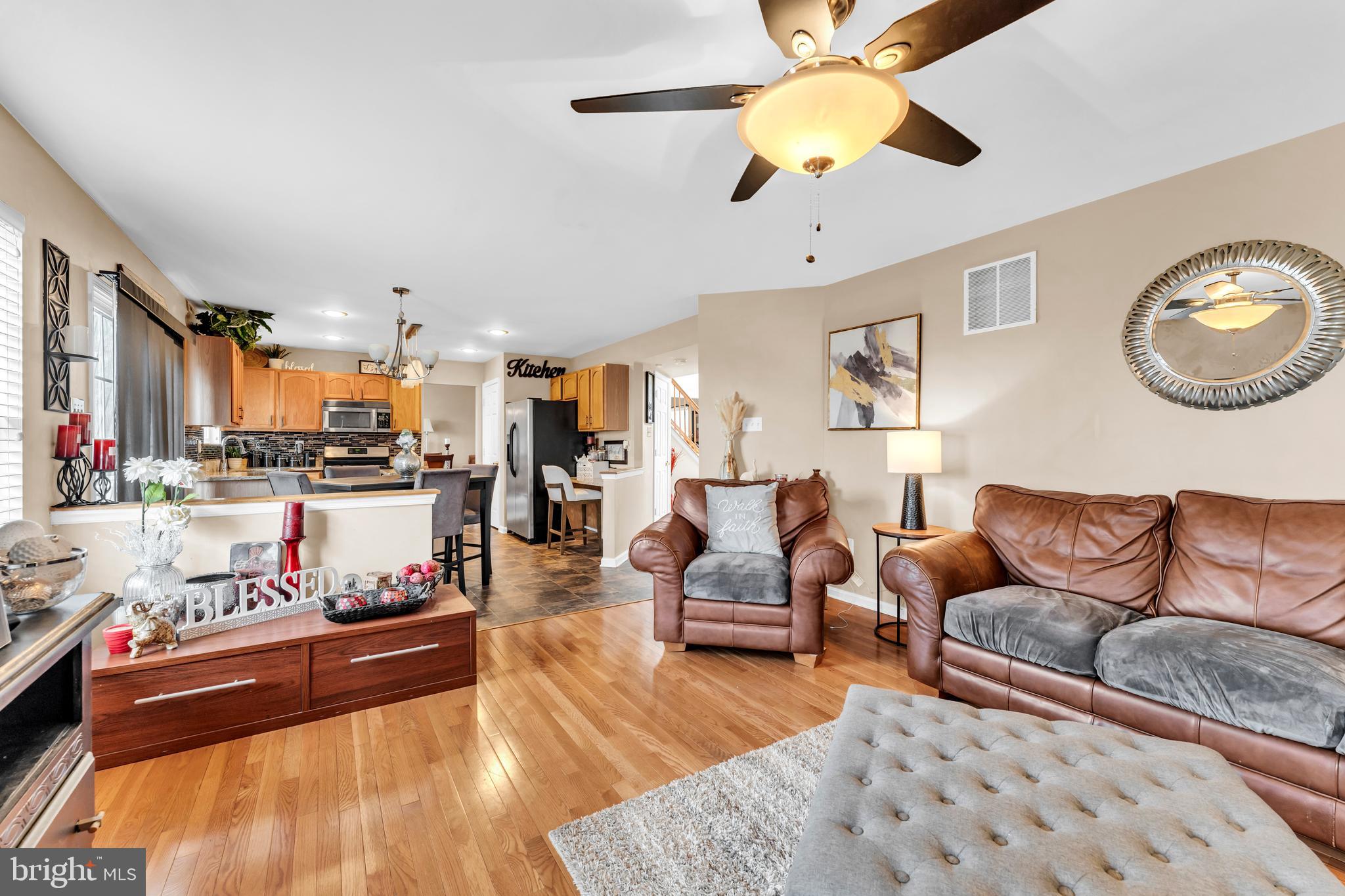 5660 Compton Lane Eldersburg, MD 21784 - Photo 13 of 44 a living room with furniture kitchen view and a chandelier