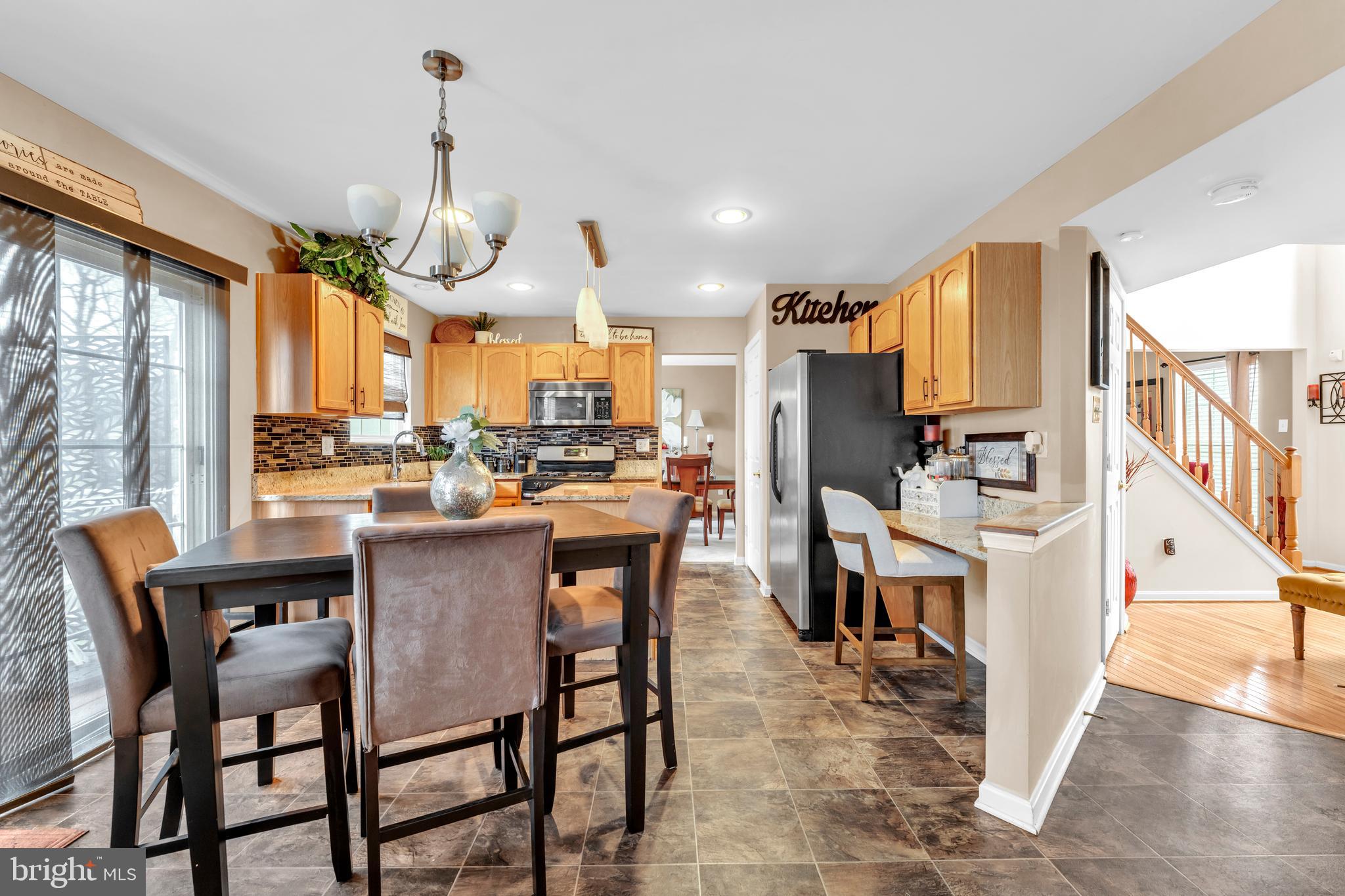5660 Compton Lane Eldersburg, MD 21784 - Photo 14 of 44 a dining room filled with furniture and a chandelier
