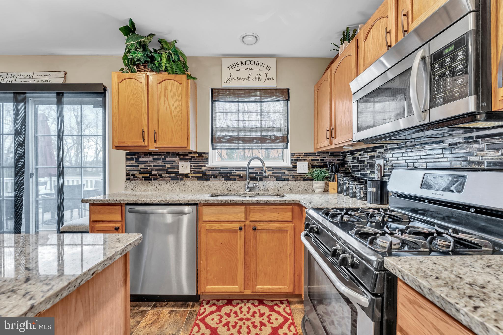 5660 Compton Lane Eldersburg, MD 21784 - Photo 17 of 44 a kitchen with stainless steel appliances granite countertop a sink stove and cabinets
